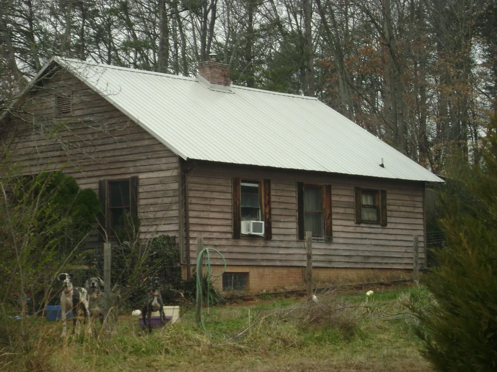 White metal roof on an old wood sided farmhouse, from a Asphalt Shingle Roof Repair job in Long Island City